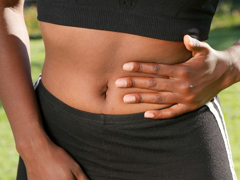 Close up of a woman doing abdominal breathing exercises